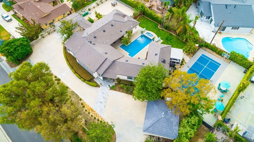 Offering indoor-outdoor living at its finest, this light-filled home boasts 4 bedrooms and 5.5 baths within 3,833 sf of re-imagined, contemporary living space in prestigious North Tustin