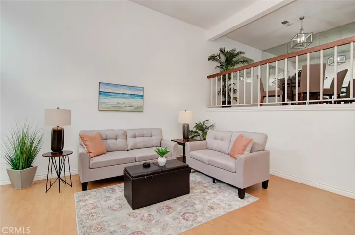 Beautiful hardwood flooring ties in really well with the banister, cupboards, and fireplace paneling
