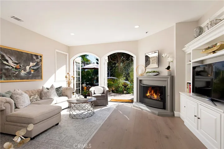 Living room w/ double French doors leading out to the front patio.
