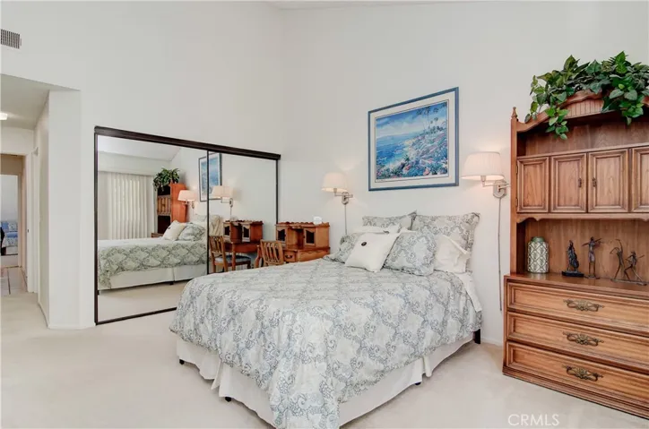 Master suite has large wardrobe closet and vaulted ceiling.