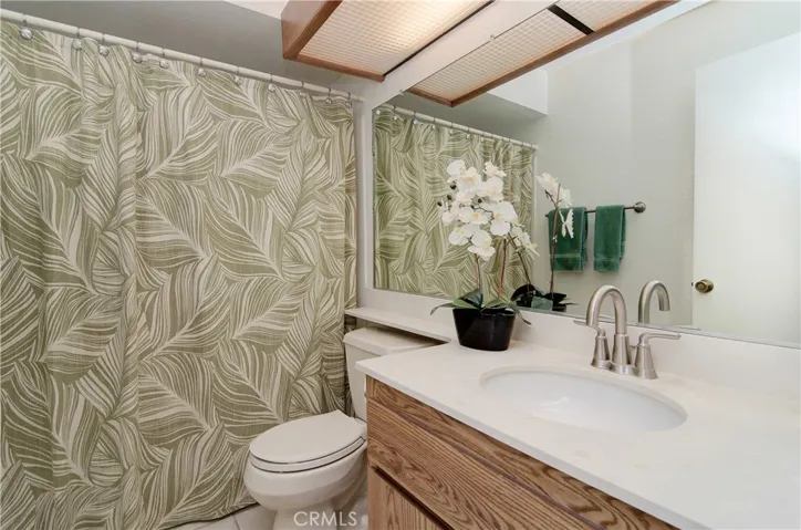 Sparkling hall bath is adjacent to bedroom and convenient for guests.