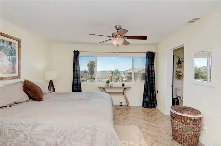 Master suite with dare I say "lay-down views," ceiling fan, double door entry and walk-in closet.