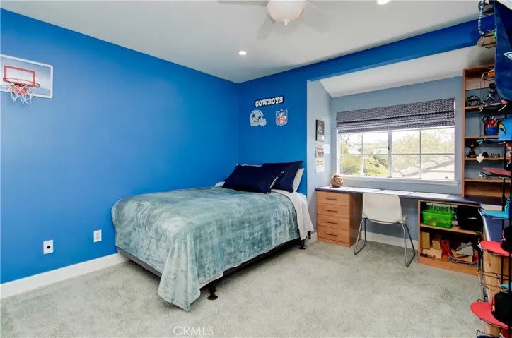 Kid's rooms have plenty of room for sleep, study and play...nice built-in shelving and desk here.