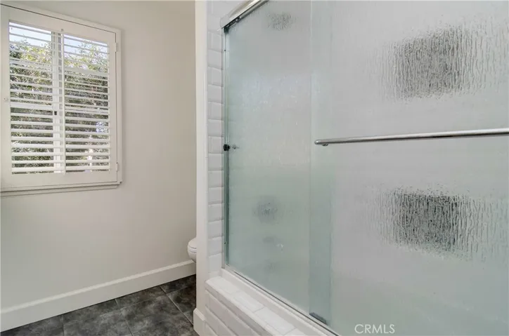 Nice tile detailing, custom enclosure and two separate shampoo niches in shower keep everyone happy.