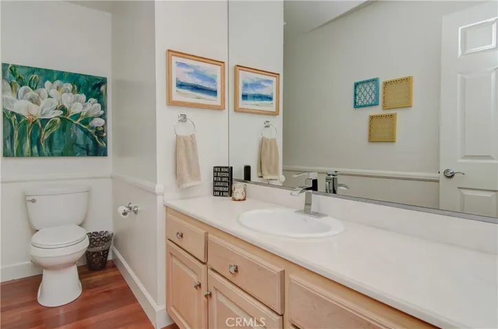 Lovely downstairs powder room has large vanity space with extra storage.