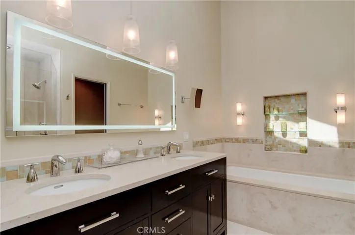 Elegant master bath has top quality fixtures and beautiful detailing.  Skylight floods the space with gorgeous natural light.