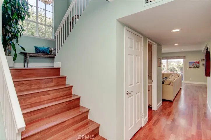 The transitions are easy here with wide halls and wide stairs...beautiful hardwood floors grace entire lower level and staircase.