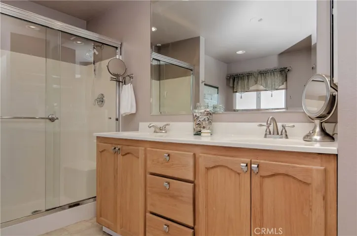 Dual sink vanity in upper master bath has contemporary fixtures and plenty of storage space.