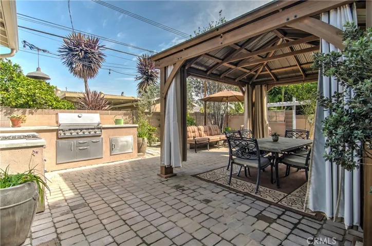 Now this is an entertainer's outdoor dream!  A complete kitchen, multiple sitting and garden areas...plus gorgeous dining pavillion