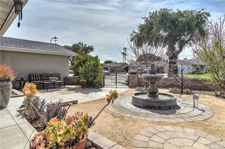 Wow is right...no detail missed here with beautiful landscape, hardscape and multiple sitting areas...lovely fountain offers tranquil sounds and anchors the space nicely.