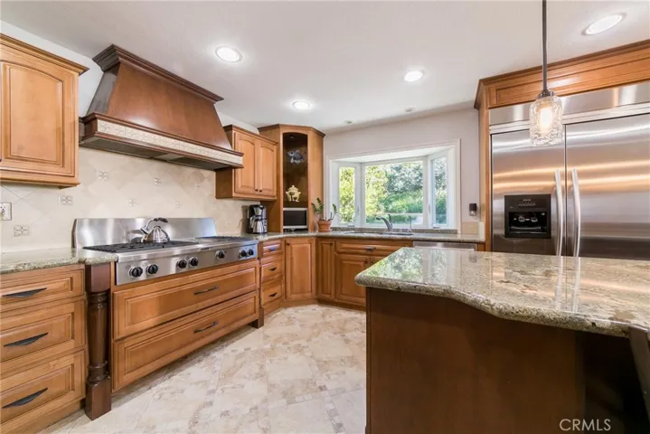 Gourmet kitchen with granite-built in fridge and much more