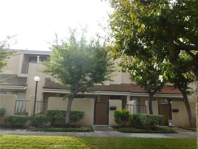Front of Townhouse.  Through gate is large patio, then into living room, entry way.