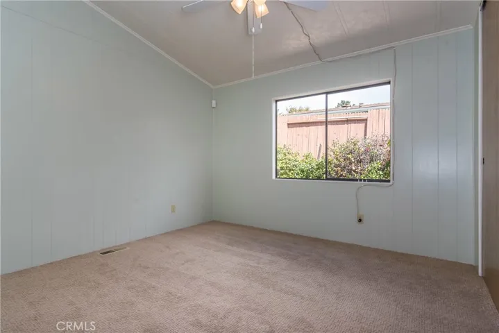 Guest bedroom with vaulted ceilings, new carpet, and fresh paint
