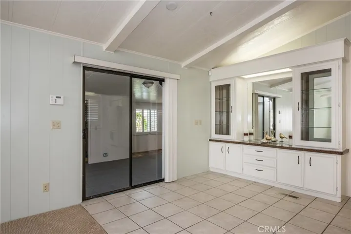 Dining area with built in hutch and a slider leading to the enclosed flex space