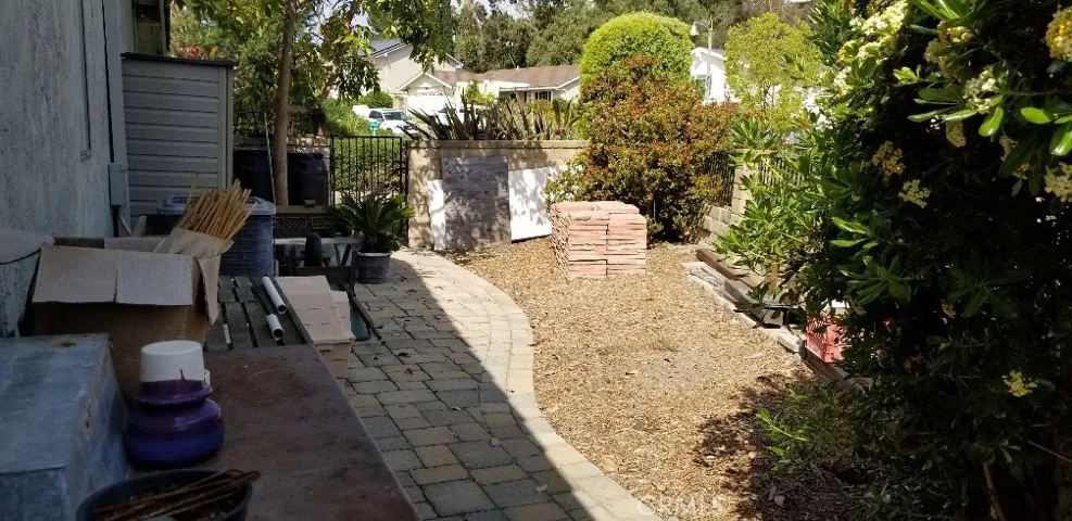 Large side yard that can be used as a garden.