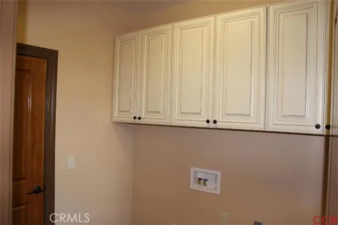Laundry area located off of kitchen/dining with door to garage