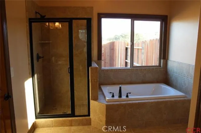 Master bath with separate tiled shower and bathtub