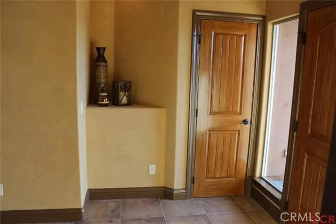 Entry way with closet and decorative shelf
