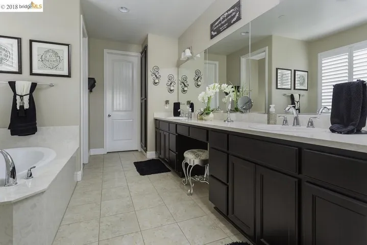 Dual Vanity Sinks, Cultured Marble counter-tops, Tile Flooring, Huge Walk in Closet!