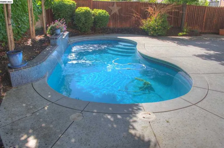 Great pool to relax in!  Features 3 sheer waterfalls, solar heat & removable safety fence.