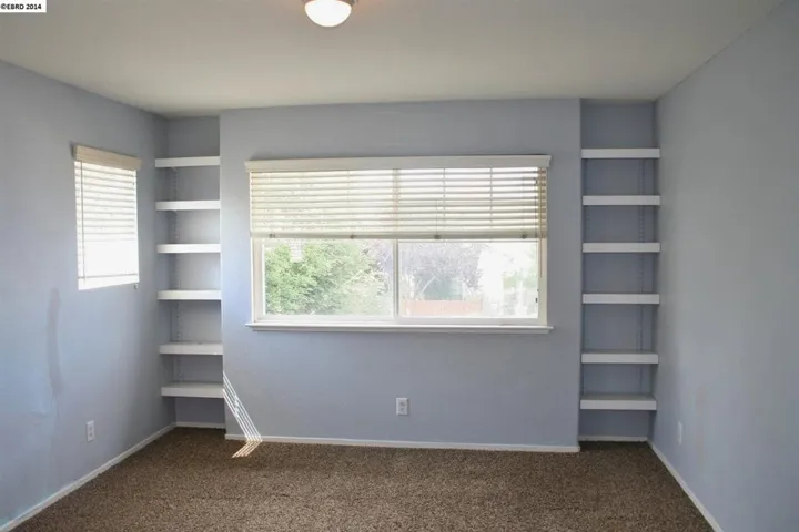 Large room with built in shelves.  Has the other access to the Jack & Jill bathroom.