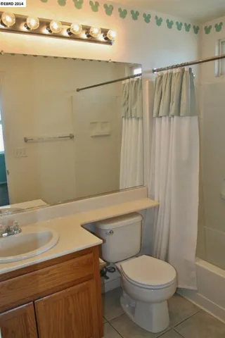 Private bathroom for bedroom 4.  Features shower over tub.