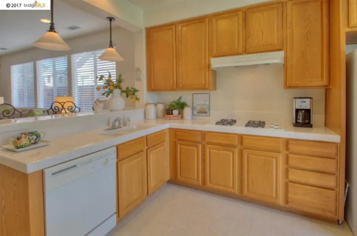 Extensive counter-space, raised eating bar area & pendent lighting!