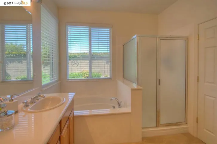 Great bathroom with dual vanity, stall shower & soaker tub!