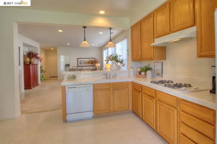 Extensive counter-space, raised eating bar area & pendent lighting!