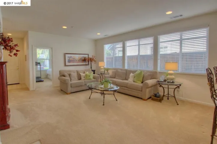 Huge family room with fireplace, lots of natural lighting & view of kitchen!