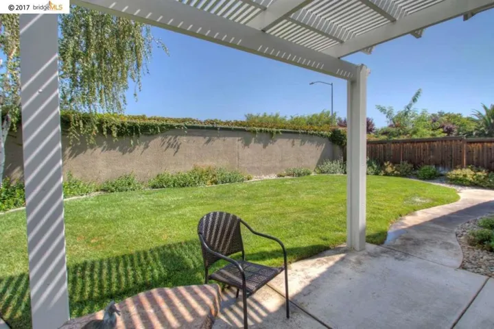 Very nice Alumawood shade structure over patio & nice yard!