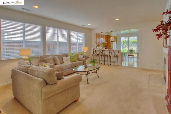 Huge family room with fireplace, lots of natural lighting & view of kitchen!