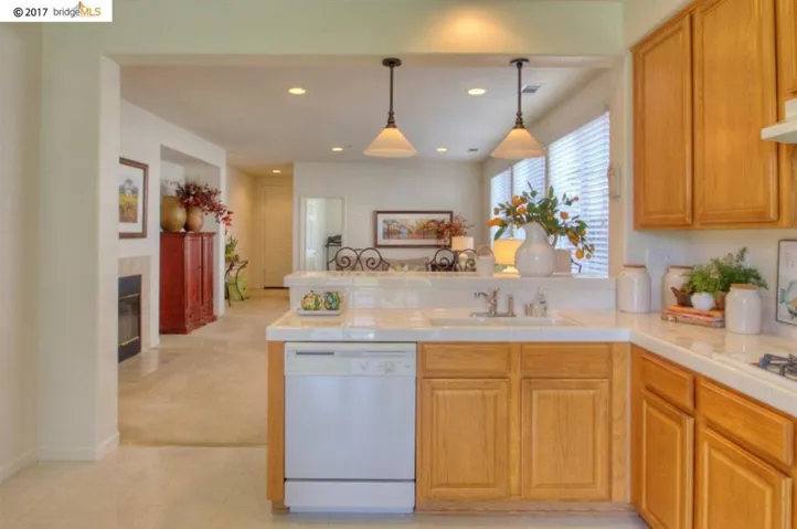 Extensive counter-space, raised eating bar area & pendent lighting!