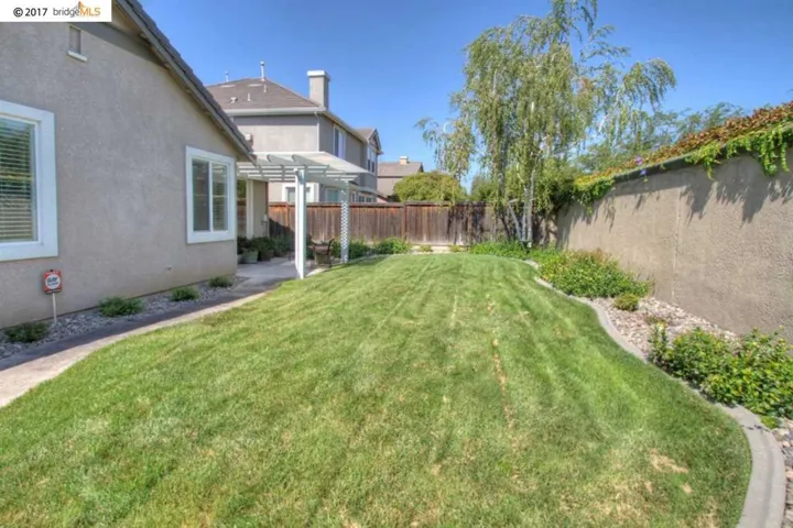 Great back yard with nice lawn & border areas, no rear neighbors!