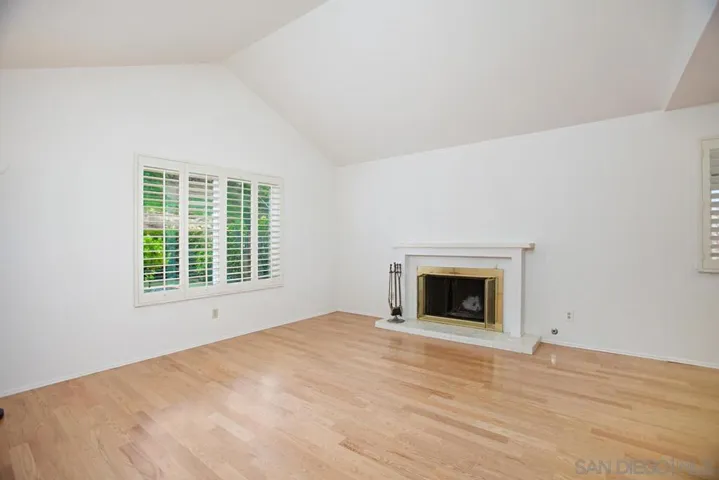 Family room with wood floors and fireplace.