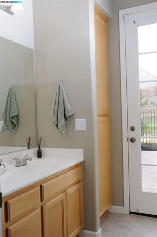 This bathroom has an exterior door to the back yard.