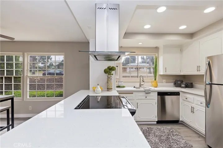 Gorgeous kitchen with quartz countertops, stainless steel appliances and recessed lighting