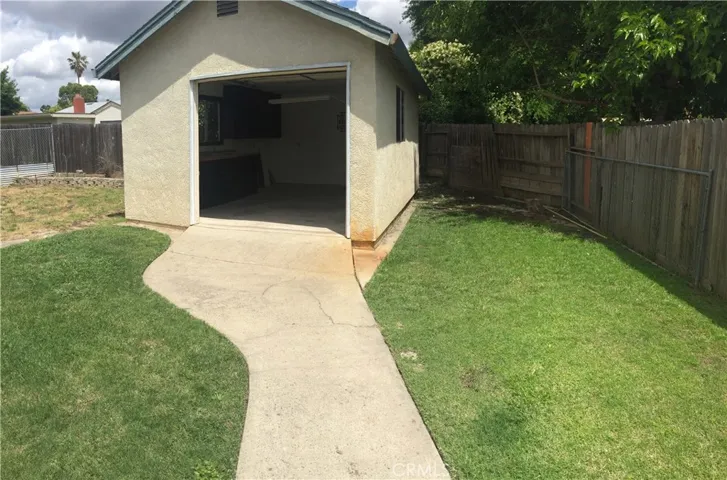 Third Garage or Workroom with Built-Ins & Roll-Up Door.