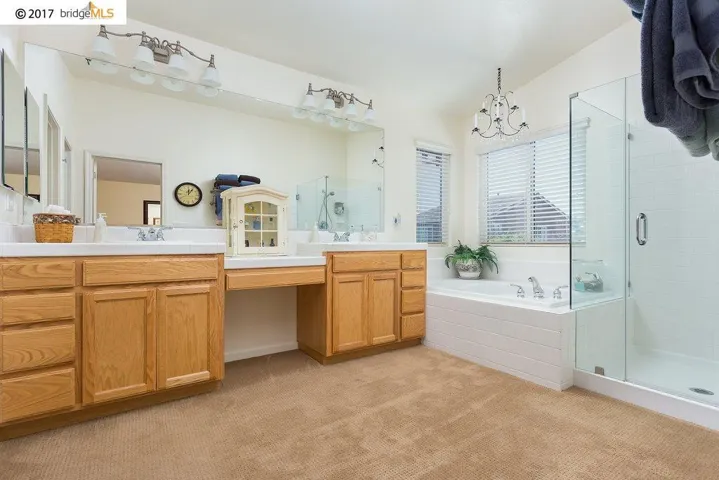 Dual Vanity Sinks, Sunken Oval Tub and Frame-less Shower Enclosure!