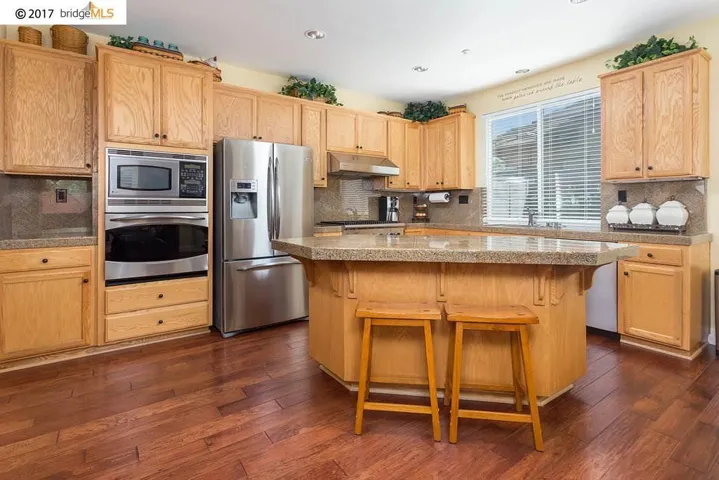 Large Open Kitchen with Granite Countertops and Stainless Steel Appliances
