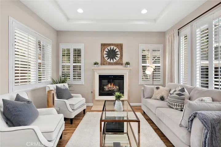 Living Room with Coffered Ceiling, Fireplace and Shutters