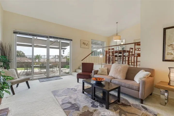 Living room and dining room looking int the backyard which has great views.  The whole house has so much natural light.