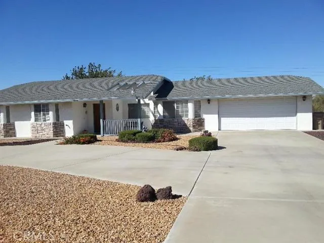 This custom built home is gated and features wonderful rock and cement hard-scape. The over sized two car garage includes overhead storage, a work shop area and a utility sink with direct access into the home.