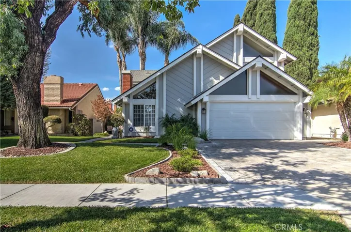 Large mature shade tree, custom pavers and walkway, lush green landscape...the curb appeal is unreal!