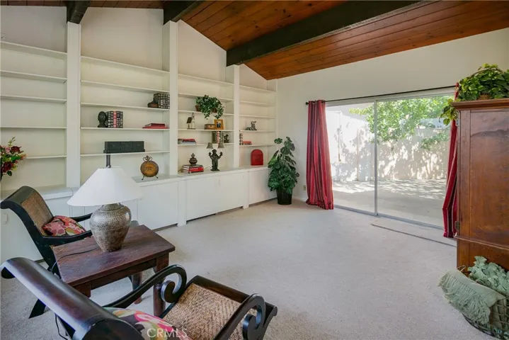 Enjoy the peaceful bonus room. Fill the shelves with books, one of the cabinets hides a desk, and the slider leads to the courtyard... Home office? Music lessons, kids hangout?