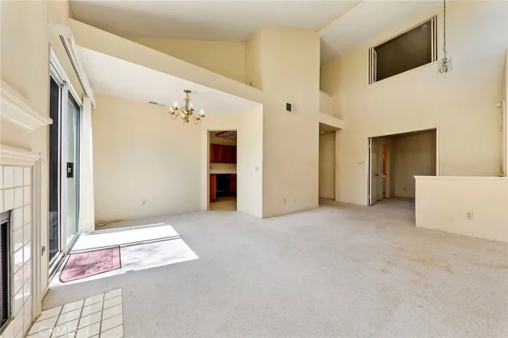 Plenty of natural light in living room with high vaulted ceiling.