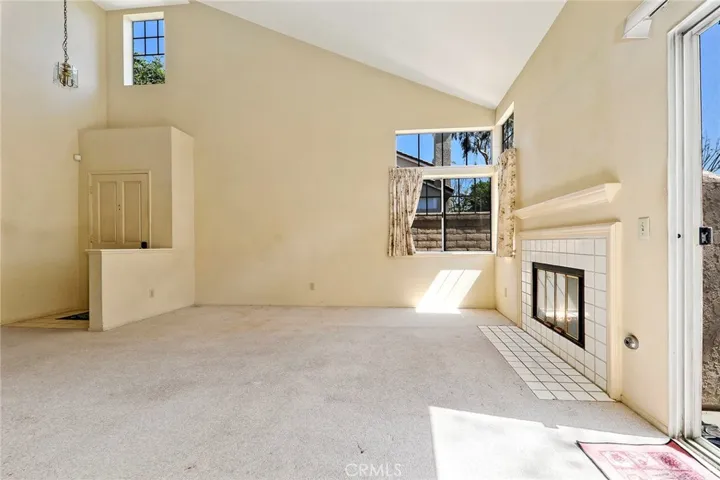 Plenty of natural light in living room with high vaulted ceiling.