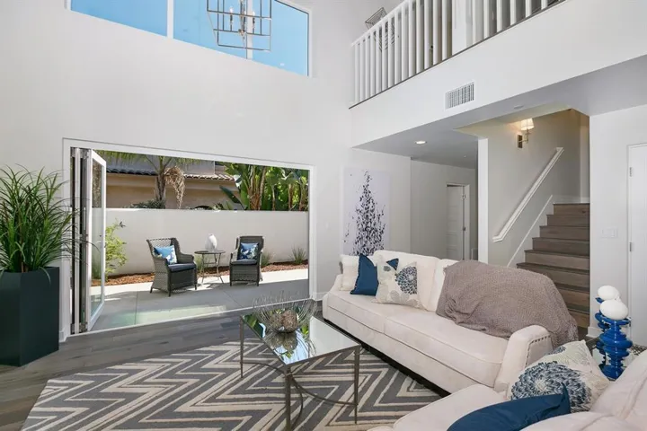 Accordion glass doors open to the backyard for indoor/outdoor living