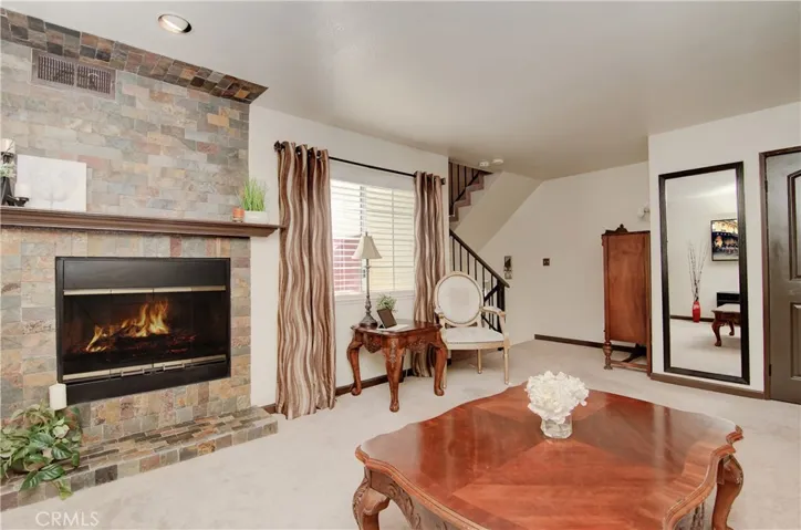 Lovely slate fireplace takes center stage and creates cozy atmosphere.