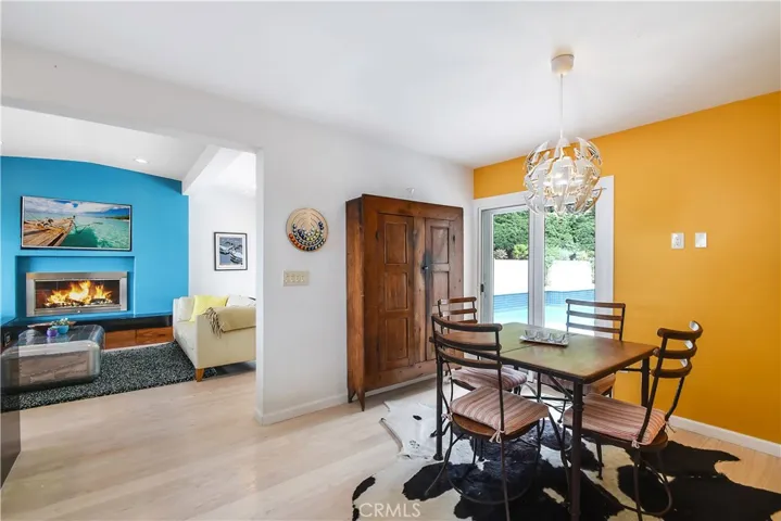 Informal dining area with slider leading to pool area.